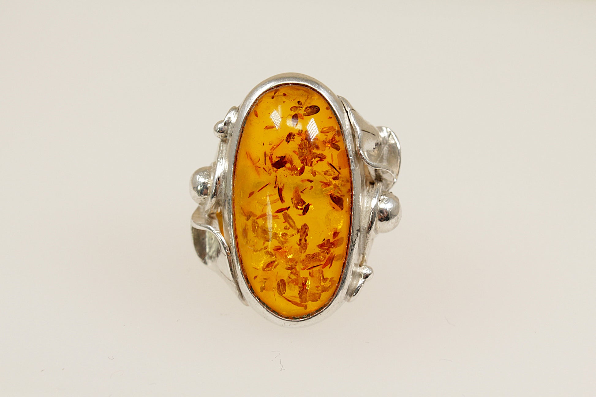 Baltic amber silver statement ring, On the outside of the band it has continental hallmarks, Polish? with the 925 stamp for sterling silver and the letters DC. UK finger size M.