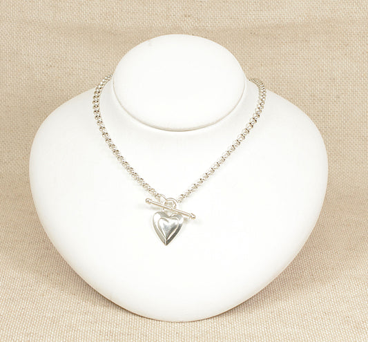A sterling silver belcher chain necklace with a 'T' bar and heart-shaped fastener displayed on a white mannequin.