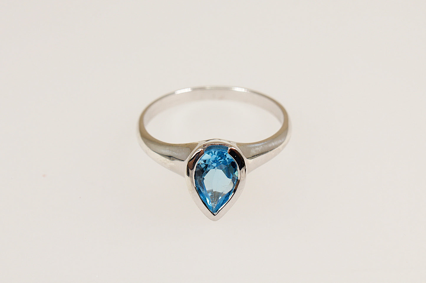 silver pear shaped blue topaz solitaire ring