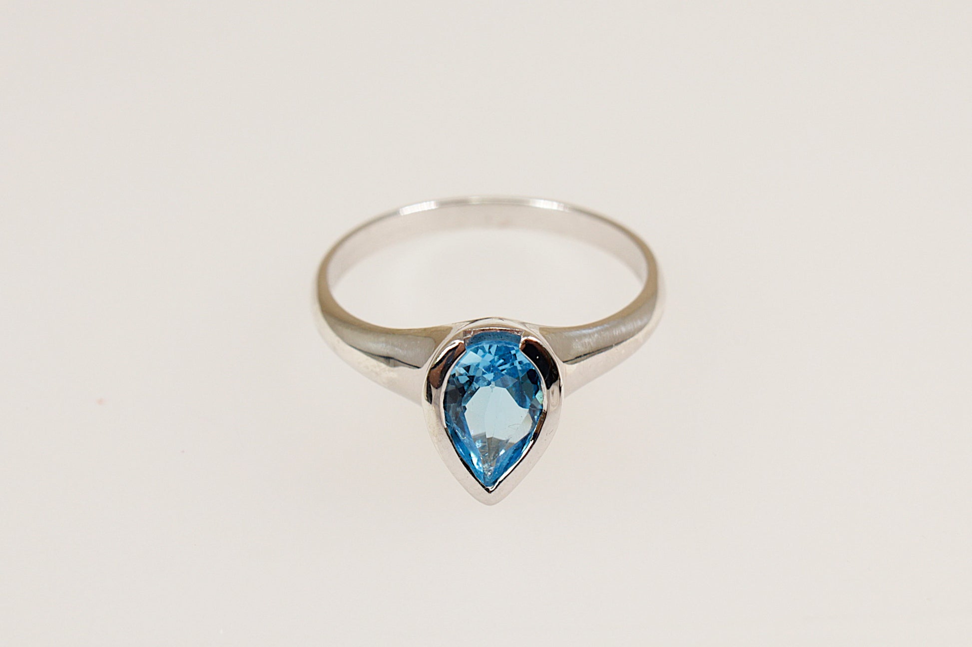 silver pear shaped blue topaz solitaire ring