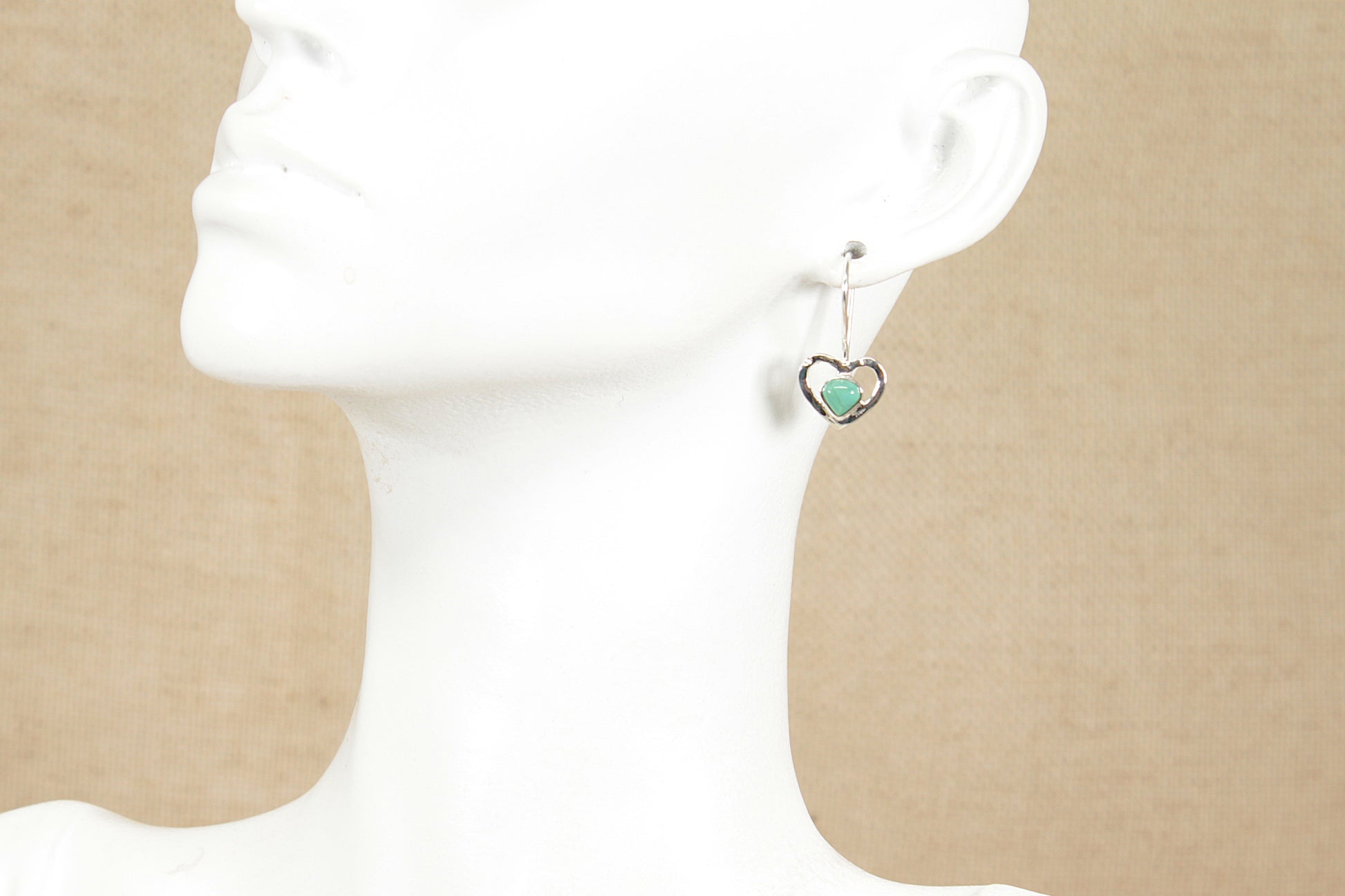 Silver and Turquoise earrings with heart-shaped turquoise gemstone on a mannequin bust.