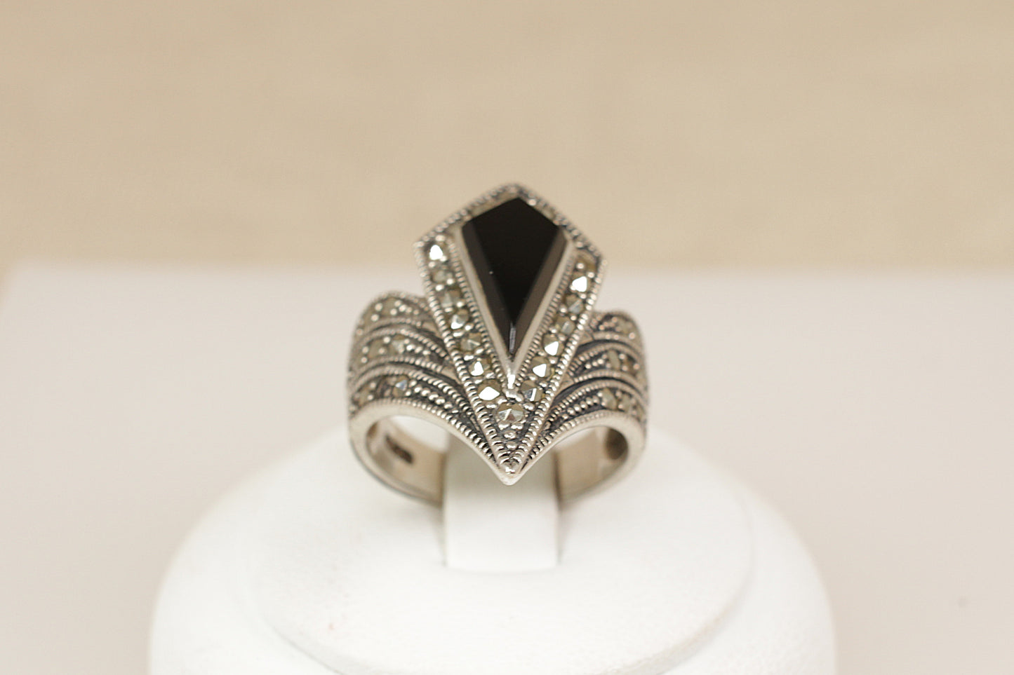 Silver Onyx Marcasite Statement Ring.
A dramatic and beautifully crafted Art Deco-inspired sterling silver ring, featuring a striking geometric pear-shaped onyx at its centre. The onyx is set within a matching pear-shaped bezel, fully encrusted with glittering marcasite stones that accentuate its bold silhouette, UK finger size M.