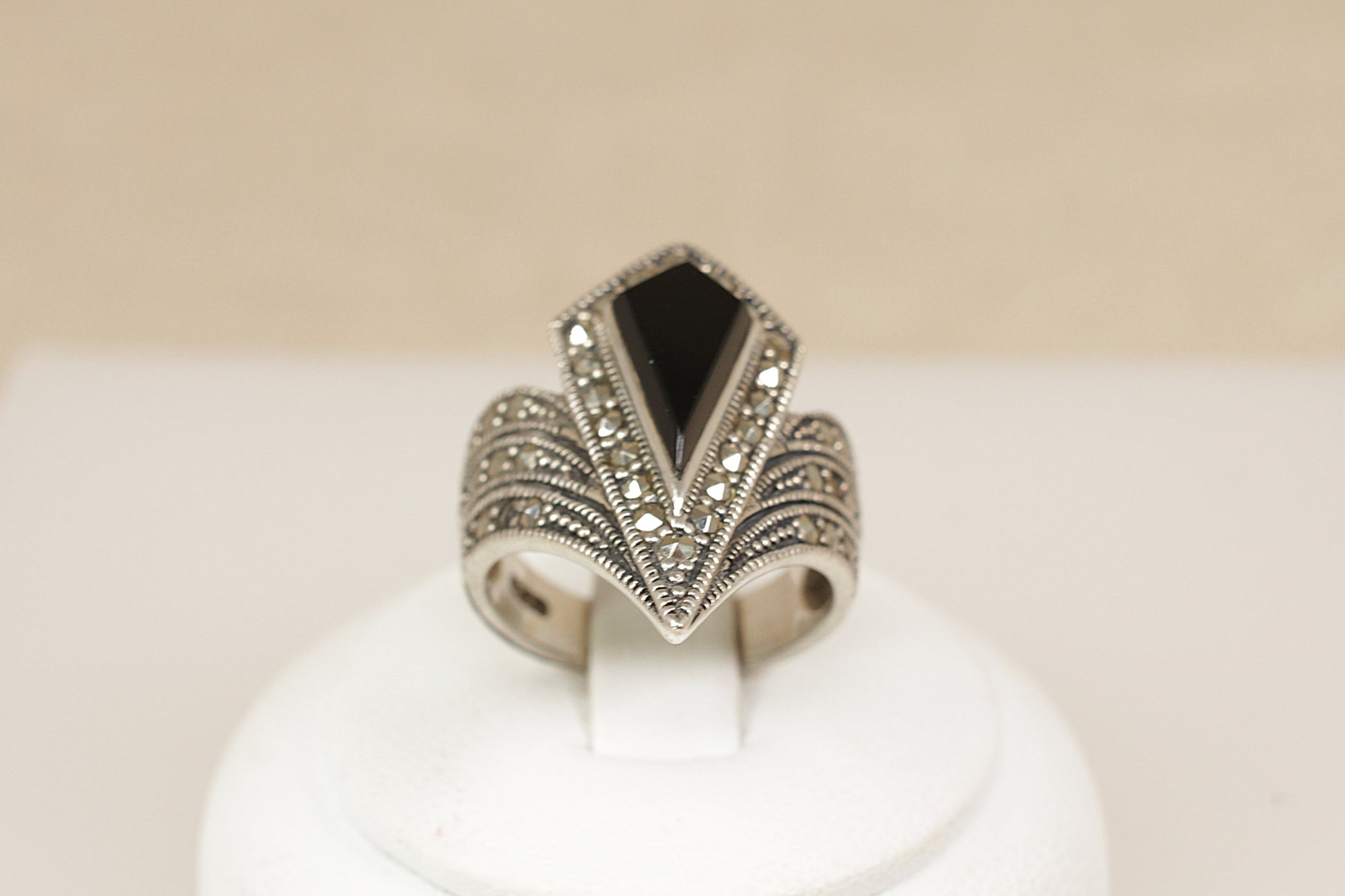 Silver Onyx Marcasite Statement Ring.
A dramatic and beautifully crafted Art Deco-inspired sterling silver ring, featuring a striking geometric pear-shaped onyx at its centre. The onyx is set within a matching pear-shaped bezel, fully encrusted with glittering marcasite stones that accentuate its bold silhouette, UK finger size M.