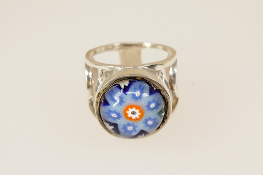 Silver ring with a blue floral design on a white background