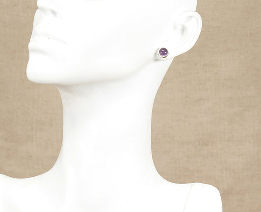 Amethyst stud earring on a mannequin with a beige background