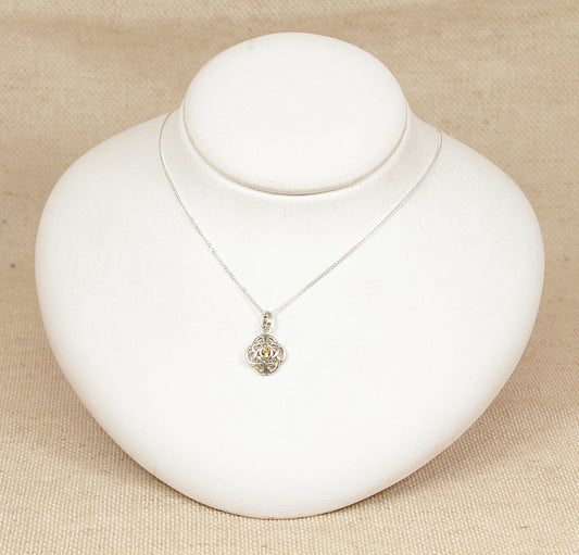 Necklace with a pendant on a white mannequin bust against a beige background