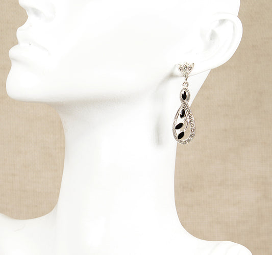 Silver earring with onyx gemstones on a white background