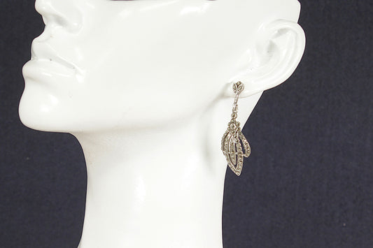 Art Deco Silver Marcasite Earring on a mannequin ear against a dark background
