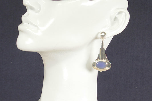 Art Deco earring with blue chalcedony gemstone on a mannequin ear against a dark background