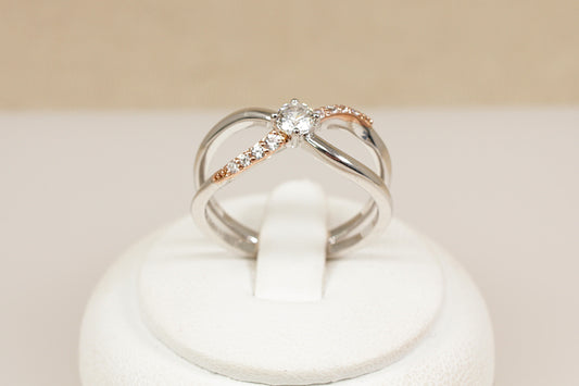 Silver Clogau Kiss Ring ring with a  topaz on a white cushion against a beige background