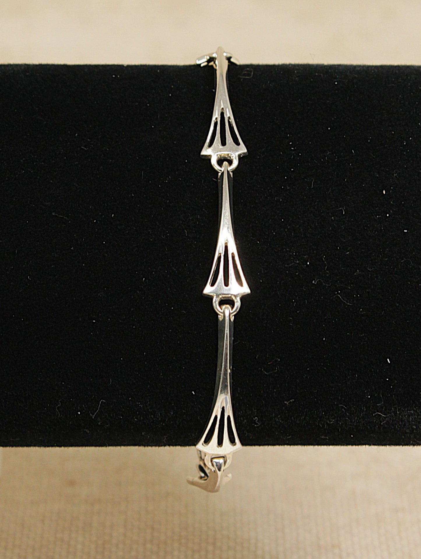 Silver bracelet on a black and beige background