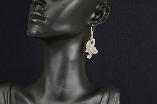 Earring on a mannequin against a dark background