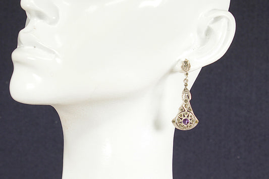 Silver Art Deco Amethyst Marcasite Earring on a mannequin ear with a dark background