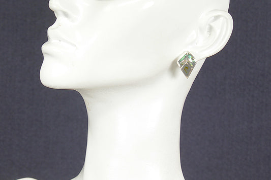 Silver abelone earring on a mannequin head against a dark background