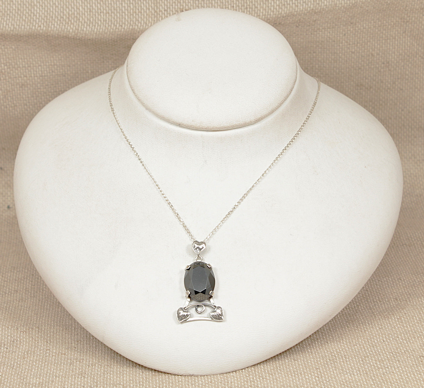 Necklace with a pendant on a white jewelry display