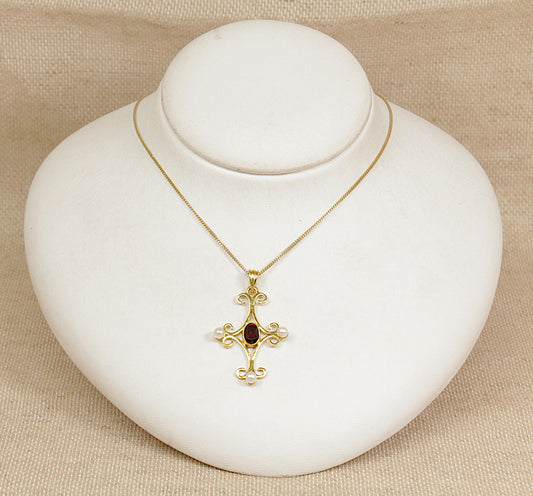 Gold necklace with a pendant on a white jewelry display