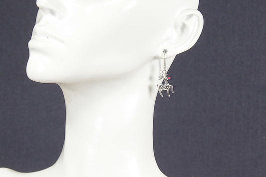 Silver earring with a small Rudolph charm on a white mannequin head against a dark background