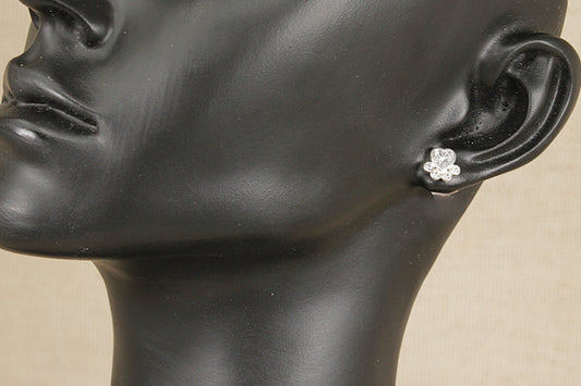 Silver heart paw print shaped crystal earring on a black mannequin ear against a beige background