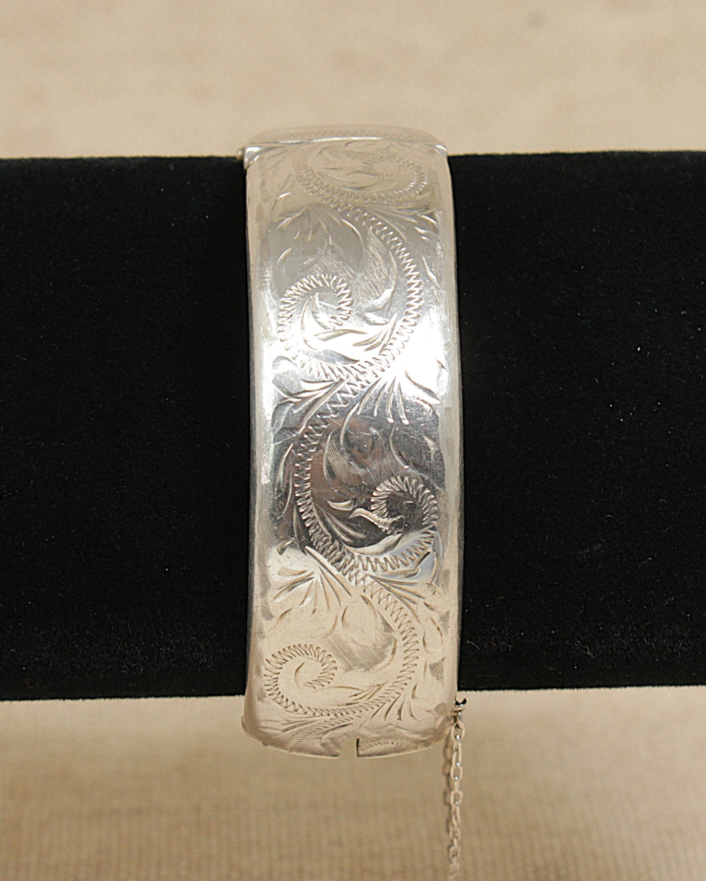 Vintage silver cuff bangle bracelet with intricate designs on a black background
