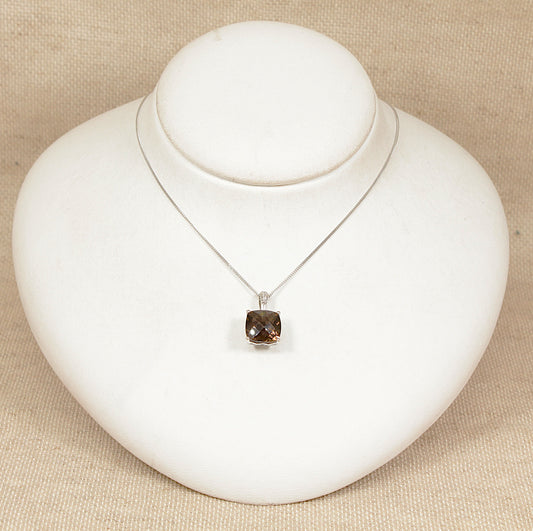 9ct white gold necklace with a smoky quartz pendant on a white stand against a beige background 