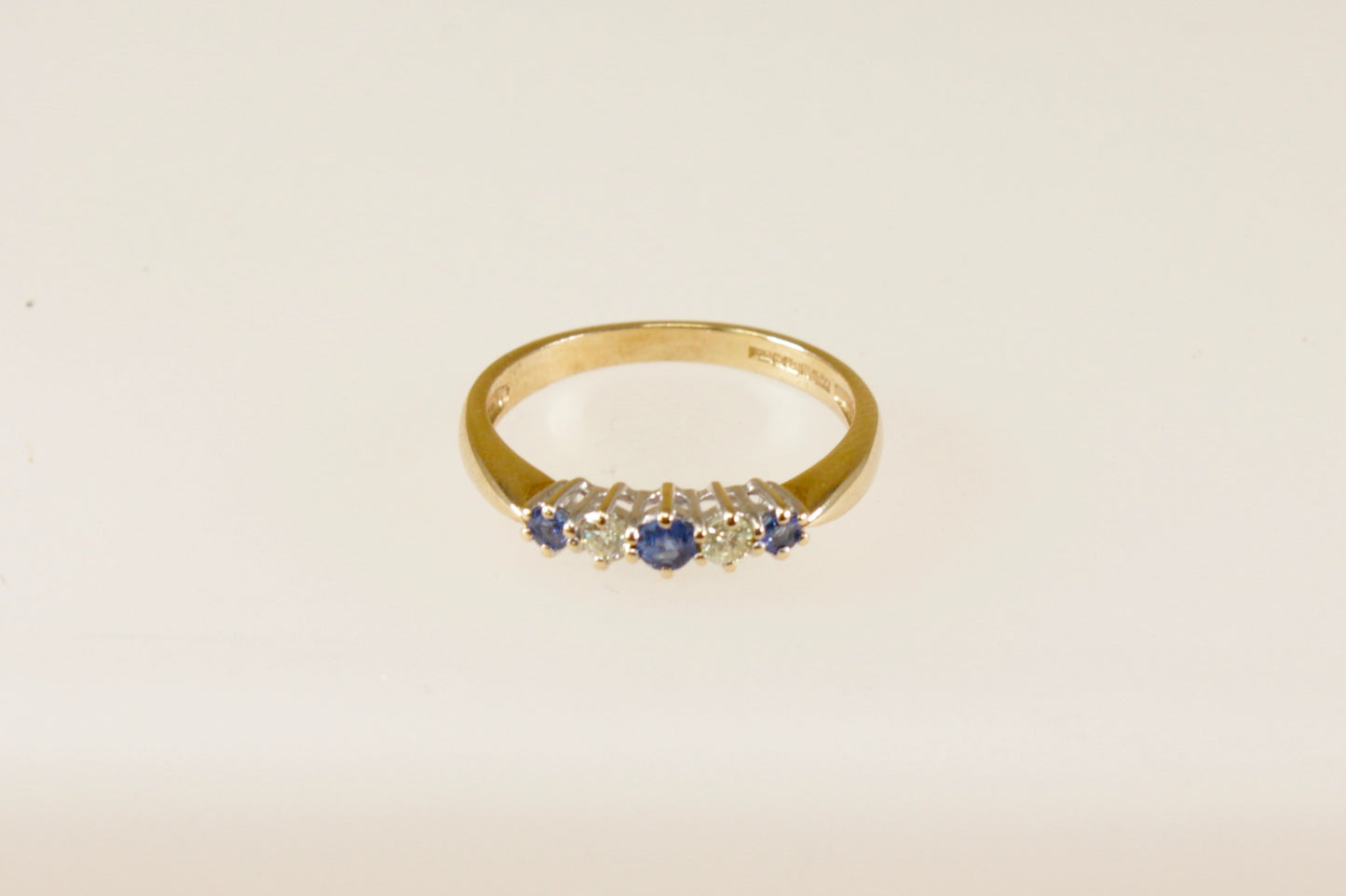 This pretty 9ct Gold ring has 3 Blue round Topaz gemstones interspaced with 2 round natural Diamonds. Inside the band it has Birmingham assay office hallmarks, also stamped DIA for the diamonds with makers mark SDJ. UK Finger size: P.