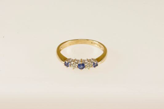 This pretty 9ct Gold ring has 3 Blue round Topaz gemstones interspaced with 2 round natural Diamonds. Inside the band it has Birmingham assay office hallmarks, also stamped DIA for the diamonds with makers mark SDJ. UK Finger size: P.