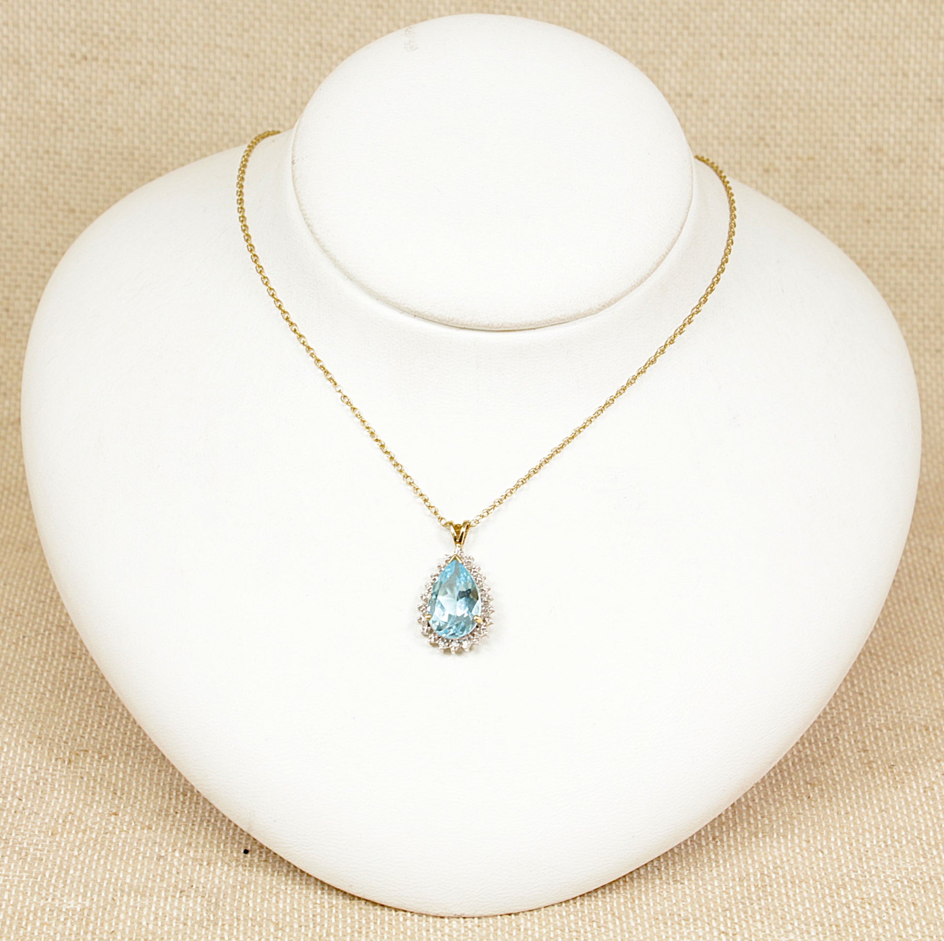 A 9ct gold blue topaz pendant with four diamond accents.  The pendant sits on an 18 inch 9ct Gold ‘Prince of Wales’ style chain, pendant and chain are in excellent condition. The pendant has Birmingham hallmarks and stamped ‘DIA’ for diamonds, the chain also has Birmingham hallmarks. Topaz: 15 x 10mm, Topaz weight: 5.5ct (estimated).