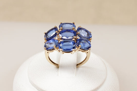 A 9ct gold ring featuring a cluster of oval-cut London blue topaz gemstones with diamond accents, The ring is in excellent condition and inside the band it has Birmingham hallmarks for 9ct Gold. UK Finger size L ½.