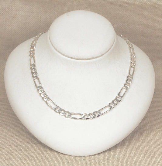 Silver Italian Figaro necklace chain on a white jewelry display
