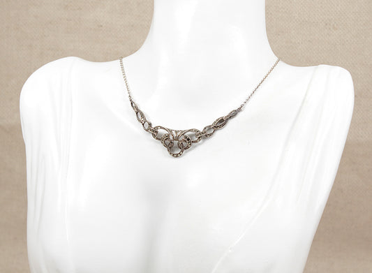  Vintage art deco Silver marcasite  necklace on a mannequin bust against a beige background
