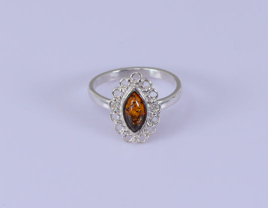 A marquise-shaped amber ring set in a silver mounting, with the ring's band displaying a 925 sterling silver stamp.