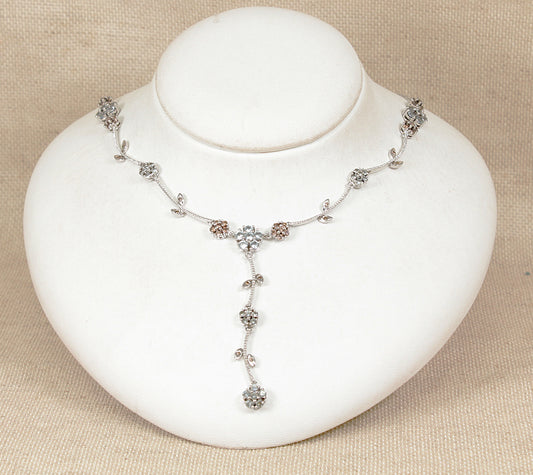 Silver blue topaz and quartz necklace on a white jewelry display