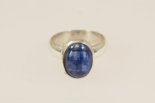A striking sterling silver ring featuring a smooth, cabochon-cut blue topaz in a sleek bezel setting, male or female, uk finger size O.