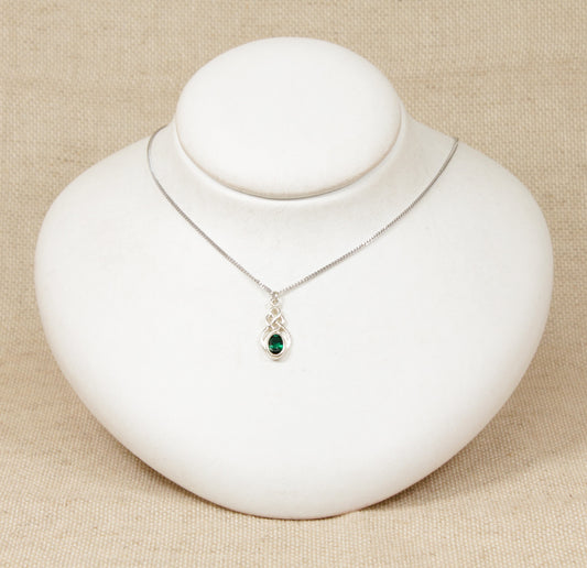 Silver Celtic Knot Crystal Pendant Necklace. This cute Silver pendant has an oval green crystal set in a Celtic knot design setting. The pendant is stamped 925 for sterling silver also the pendant sits on a silver 18 inch flat curb chain which is also stamped 925.
