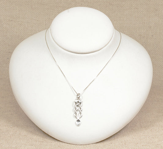 A silver Celtic knot pendant necklace displayed on a white mannequin bust against a beige background.
