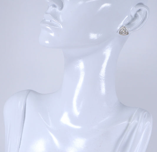 A pair of silver Celtic knot stud earrings displayed on a mannequin head.