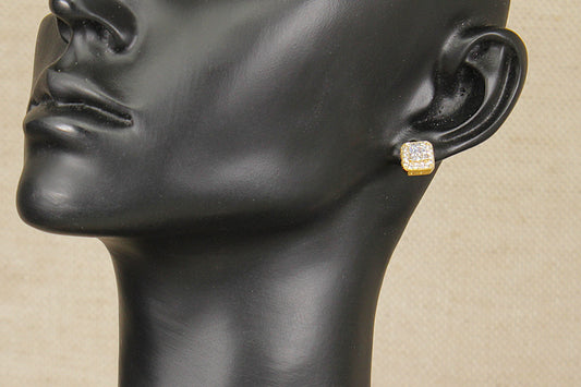 Silver gilt and cz earring on a black mannequin head against a beige background