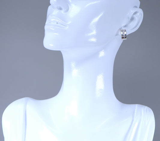 These lovely silver stud earrings are rectangular in shape with a curved design, there are 3 square and one round Cubic Zirconia gemstones set in solid silver. A pair of cubic zirconia earrings would add a touch of delicate sparkle to any look both day or night.
The earrings are stamped 925 for sterling silver. Length : 12mm, Width: 6mm.
