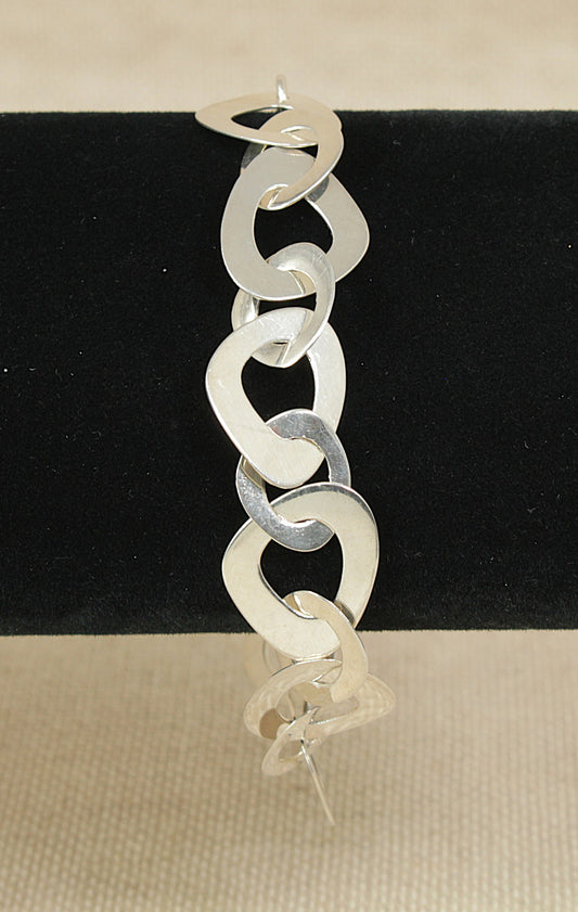 Silver chain bracelet on a black and beige background