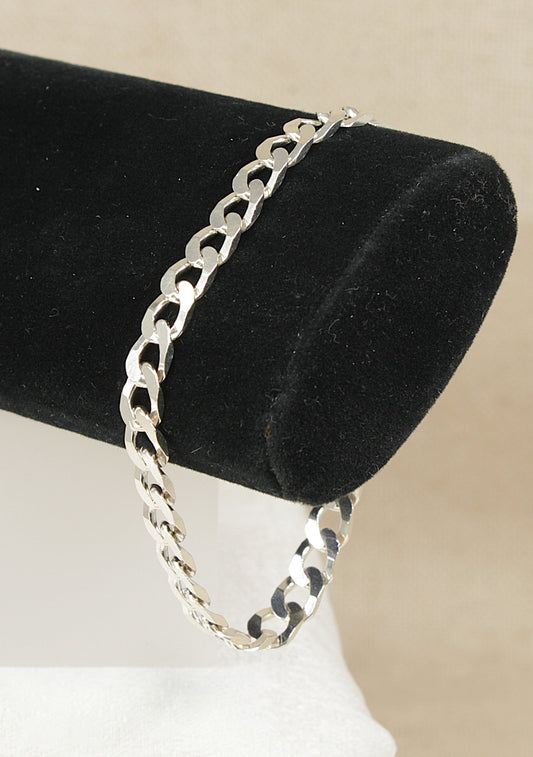 Silver flat curb link bracelet on a black bracelet stand.
