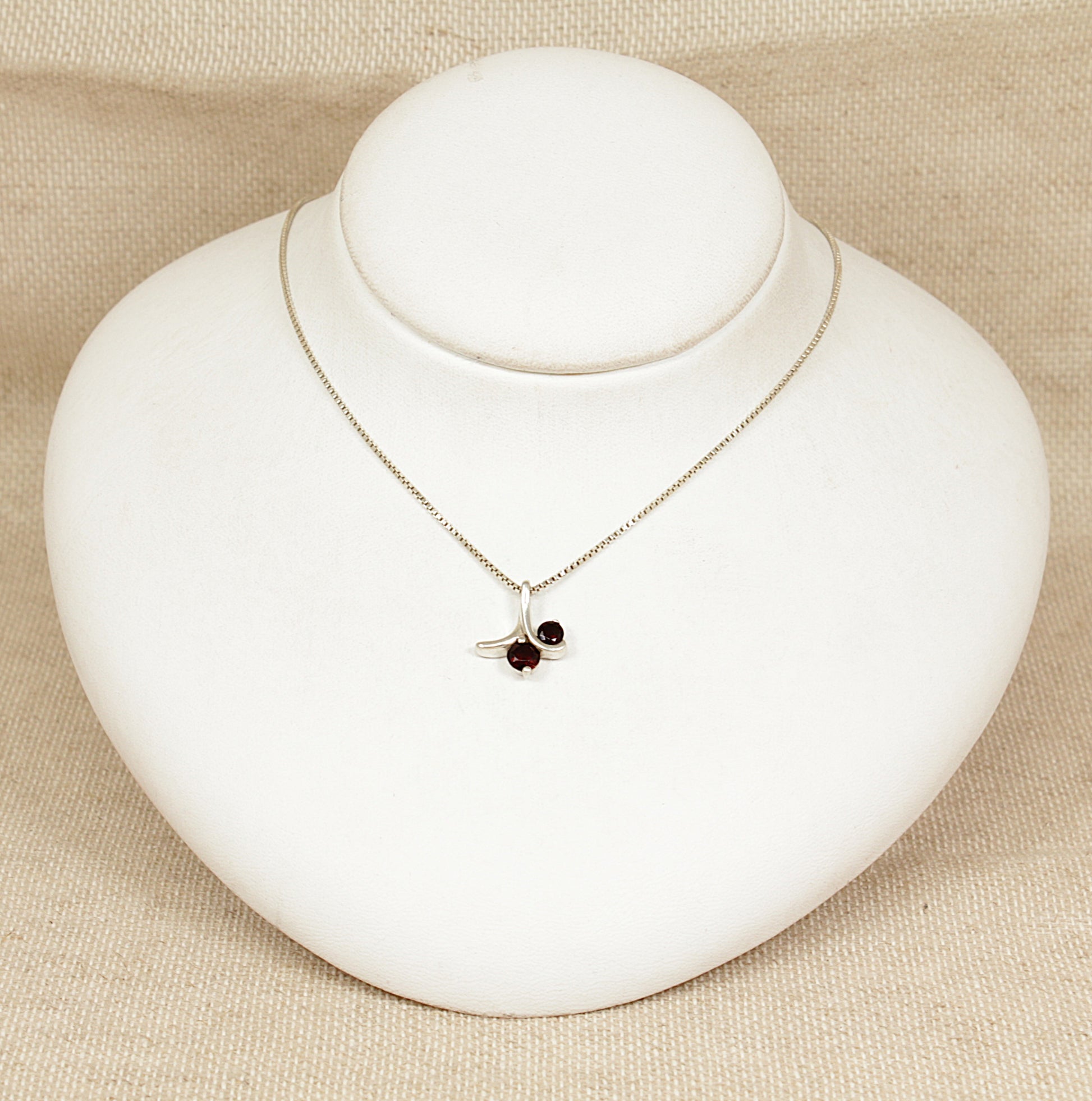 Necklace with a pendant on a white jewelry display