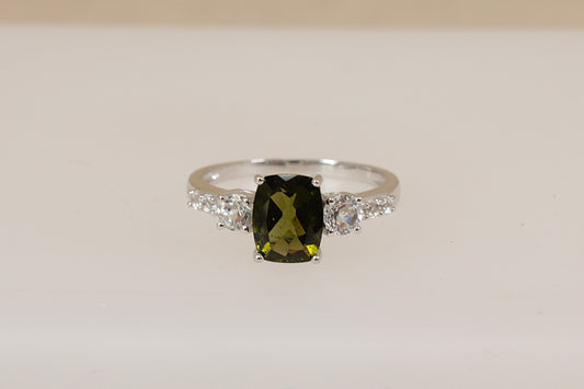 Silver Ring with a green amethyst  gemstone and white topaz accents on a beige background
