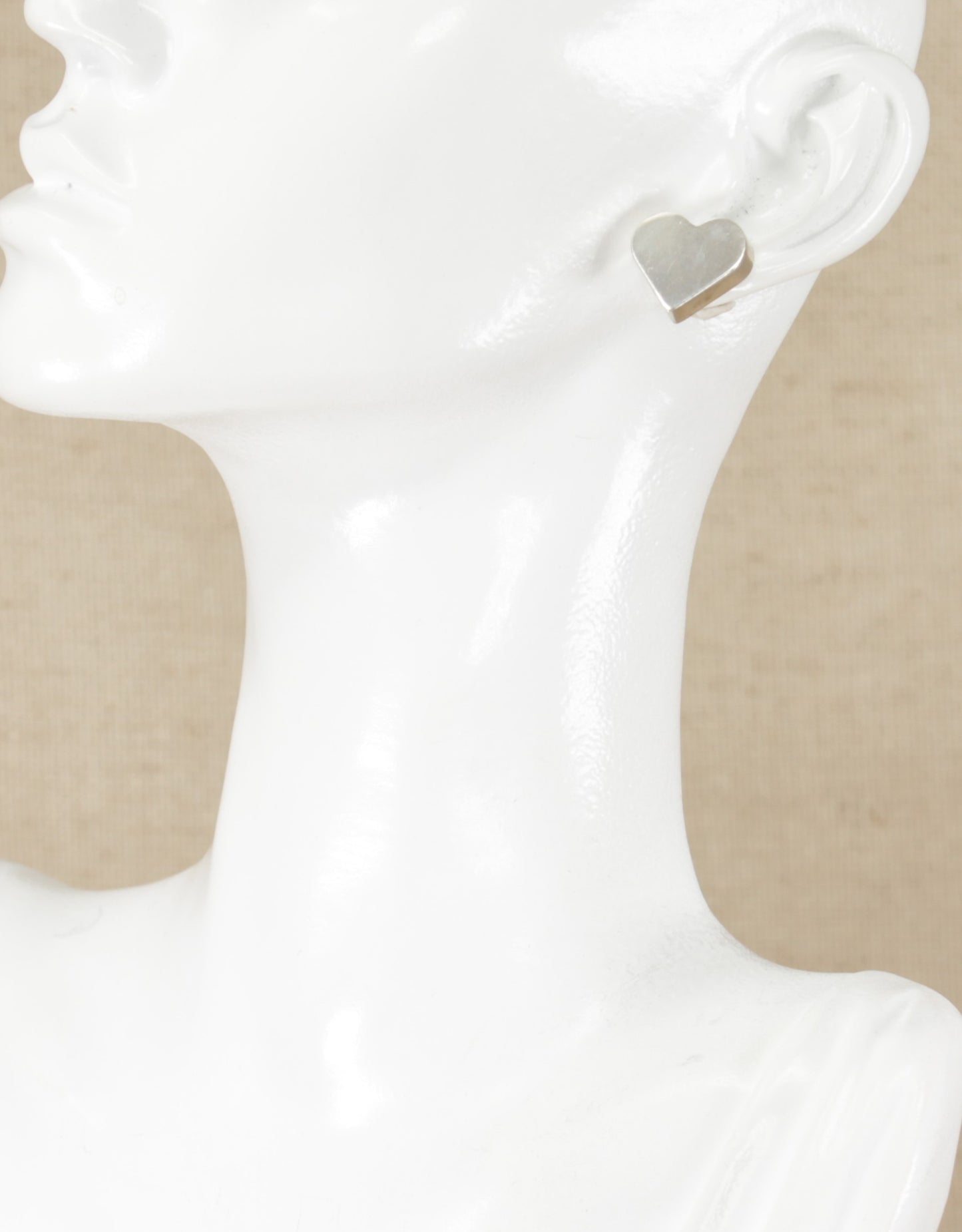 These stylish Silver Stud Earrings are in a heart shape design. They are stamped 925 for sterling silver and are in excellent condition. Length: 14mm, 
Width: 15mm, Thickness: 4mm.