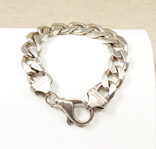 This heavy Solid Silver bracelet is both stylish and practical, suitable for everyday wear or as a statement piece. 
The ‘flat curb link‘ design is an interlocking link with a smooth appearance, it has a robust Lobster clasp known for it’s durability and ease of use. It is in great condition and stamped 925 for sterling silver. Length: 8 inch, Link size: 15mm wide, Link thickness: &nbsp;4.5mm, Weight: 71g