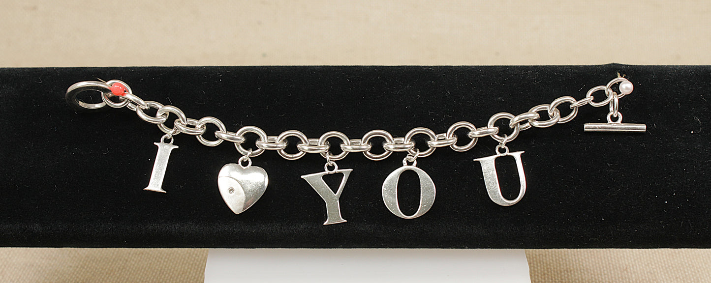 Silver bracelet with 'I LOVE YOU' charms on a black stand