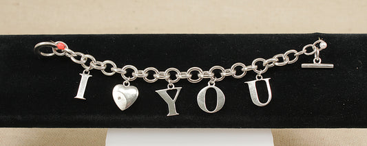 Silver bracelet with 'I LOVE YOU' charms on a black stand