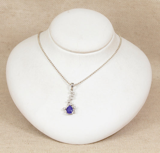 Necklace with a purple lapis lazuli pendant on a white jewelry display