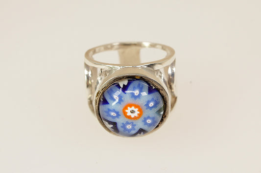 Silver ring with a blue floral design on a white background