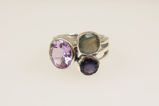 This stunning new Silver ring features 3 large faceted gemstones, Amethyst, Blue Iolite and Labradorite. Set in a stylish and contemporary split band design, it is a bold and artistic statement piece. UK finger size O.