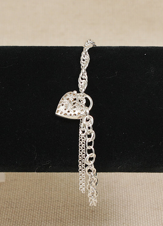 Silver bracelet with heart charm on a black stand